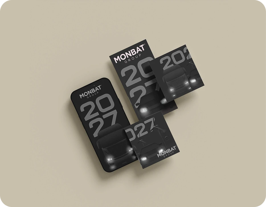 Monbat Group 2027 campaign creatives on a phone and printed cards