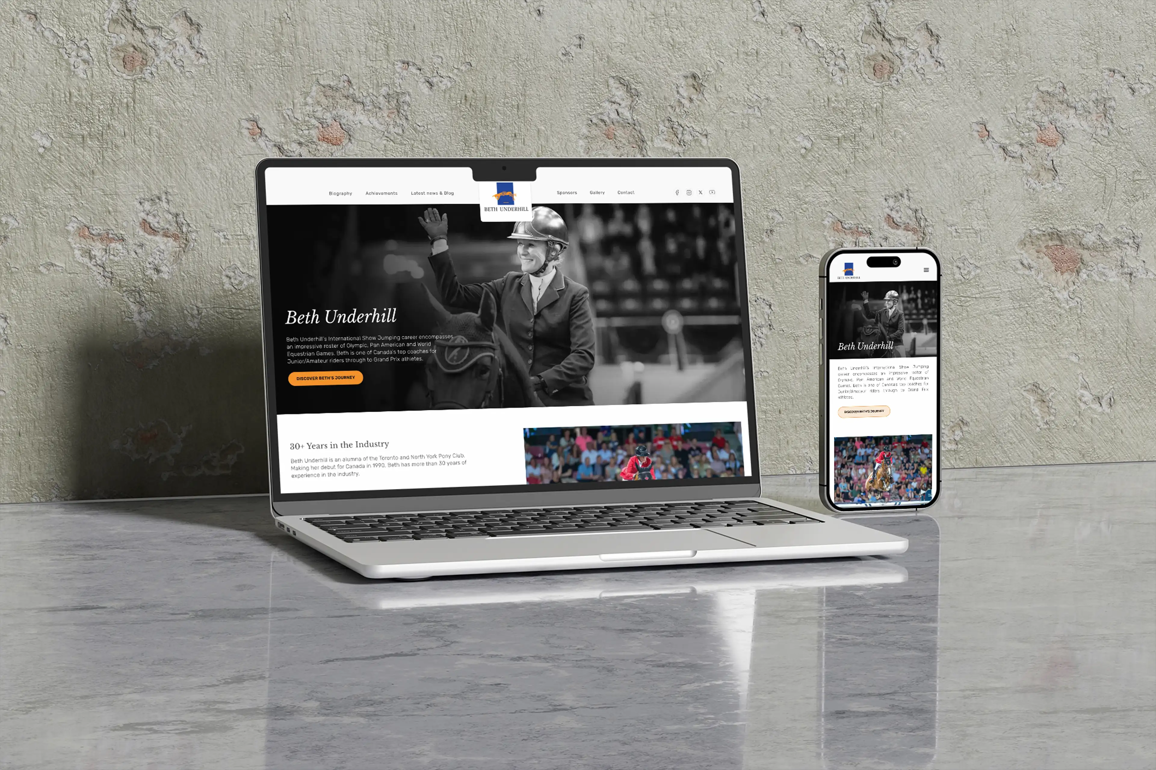 The Beth Underhill website shown on a laptop and iPhone against a concrete wall