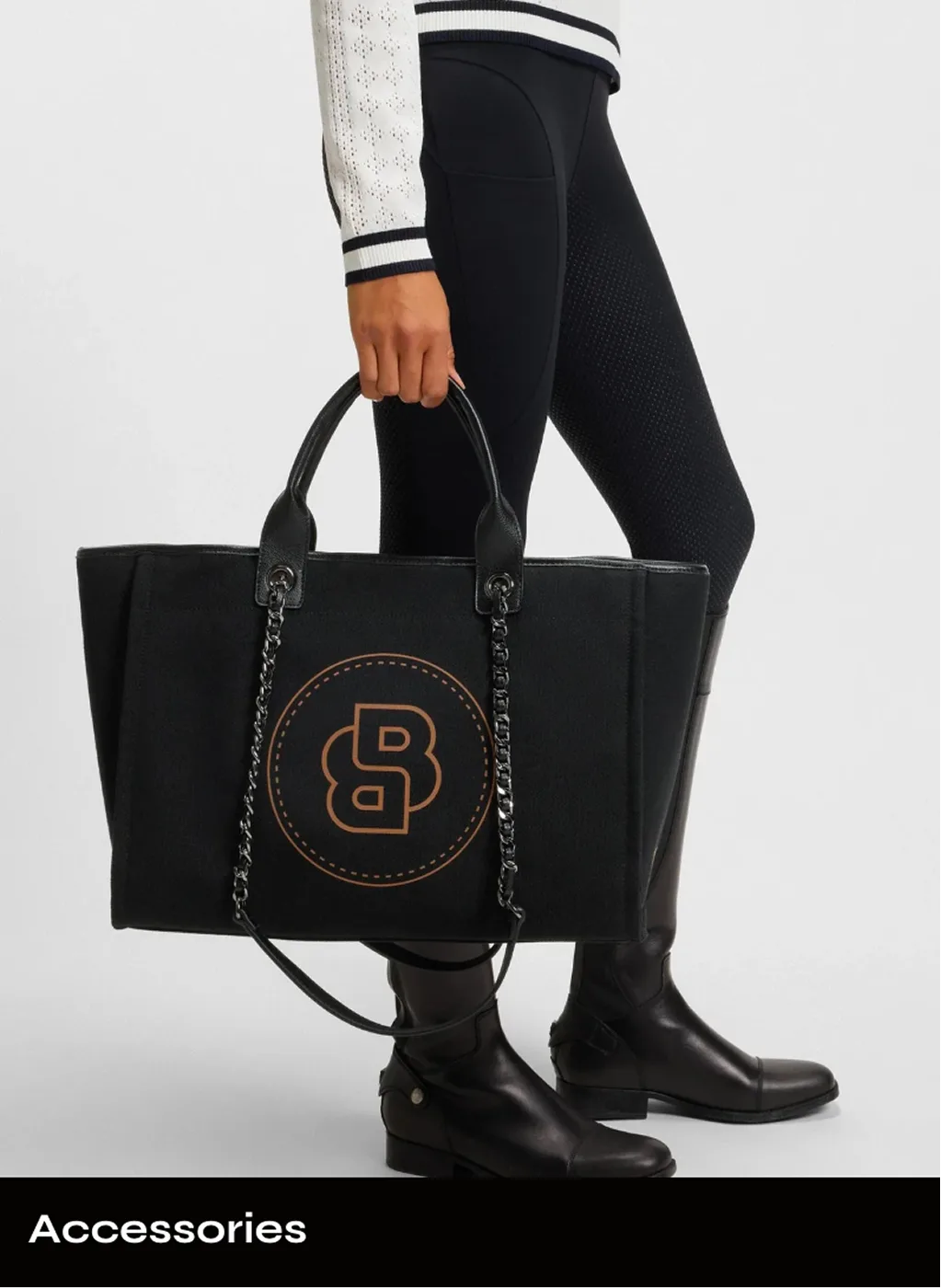 A rider holding a black BOSS tote bag under an Accessories label