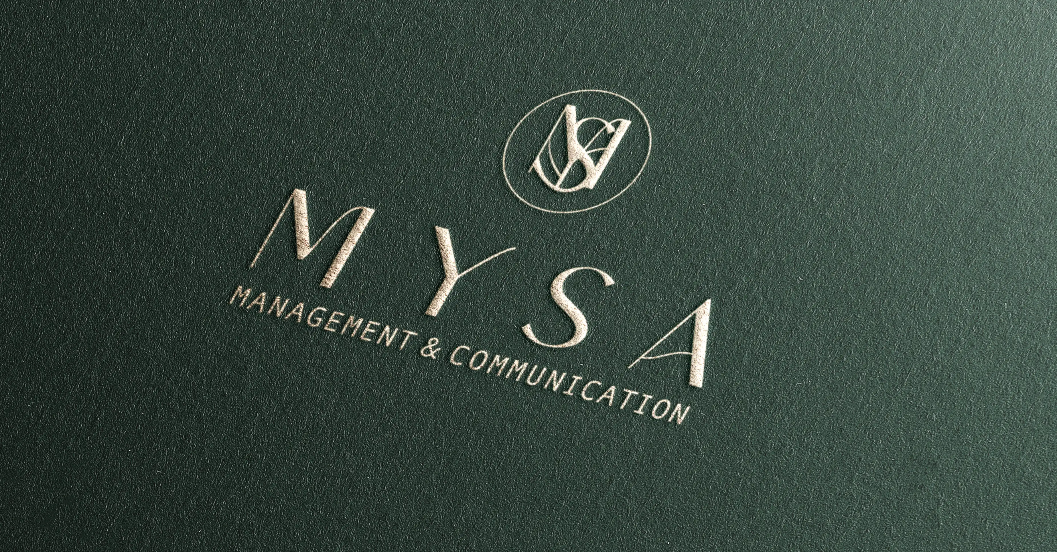 The MYSA wordmark embossed on a deep green textured surface