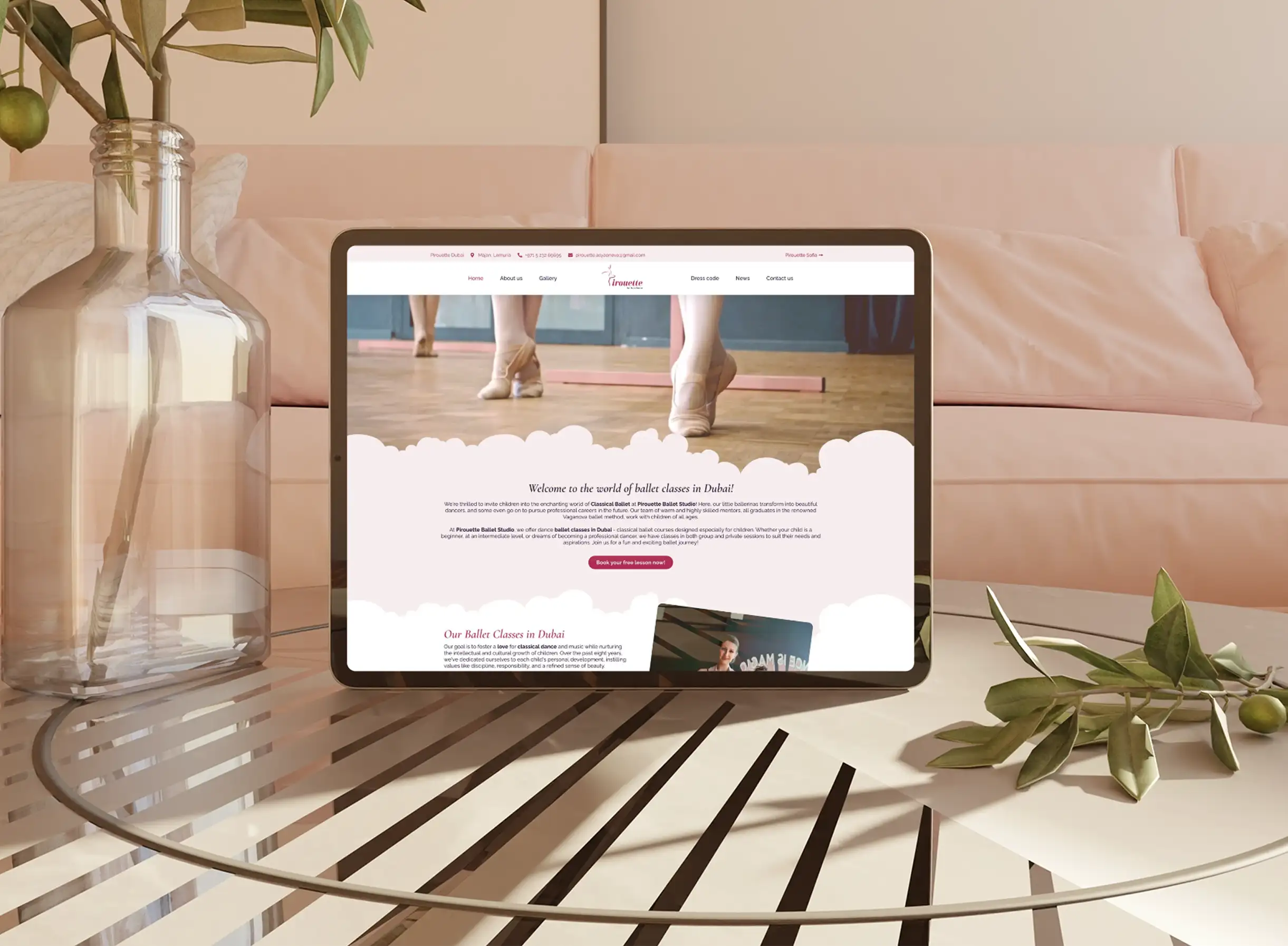 The Pirouette Studio website on a tablet resting on a glass table in a soft pink room